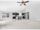 Open-concept living space with modern kitchen, adjacent to carpeted living room under a ceiling fan at 5409 Brandywine Dr, Whitestown, IN 46075