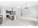 Bright open-concept space with tile floor and modern kitchen, flowing into a carpeted living area at 5409 Brandywine Dr, Whitestown, IN 46075