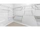 A well-organized walk-in closet with adjustable white shelving and carpet flooring at 5409 Brandywine Dr, Whitestown, IN 46075