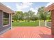Spacious back deck overlooks a beautiful yard with lush green grass and mature trees at 5695 N Red Oak Dr, Greenfield, IN 46140