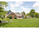 Spacious backyard with a charming brick home, garden and a playset at 5695 N Red Oak Dr, Greenfield, IN 46140