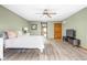 This bedroom has hardwood floors, a ceiling fan, and an ensuite bathroom at 5695 N Red Oak Dr, Greenfield, IN 46140