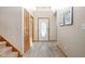 Bright foyer with wood-look floors, stairs and decorative front door at 5695 N Red Oak Dr, Greenfield, IN 46140