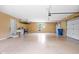 Spacious garage with a service door, an overhead storage rack and epoxy flooring at 5695 N Red Oak Dr, Greenfield, IN 46140