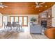 Open living room with a fireplace, wood-paneled ceiling, and access to outdoor area at 5695 N Red Oak Dr, Greenfield, IN 46140