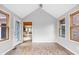 Sunroom with views into the kitchen, glass door, and brick exterior at 5695 N Red Oak Dr, Greenfield, IN 46140
