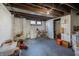 Unfinished basement with painted walls, visible utilities, and a bicycle at 6101 Broadway St, Indianapolis, IN 46220