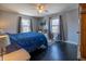 Primary bedroom with hardwood floors, ceiling fan, and natural light at 6101 Broadway St, Indianapolis, IN 46220