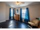 Spacious bedroom with hardwood floors and natural light from two windows at 6101 Broadway St, Indianapolis, IN 46220