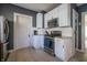 Renovated kitchen with stainless appliances, white subway tile backsplash, and light tile floors at 6101 Broadway St, Indianapolis, IN 46220