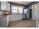 Updated kitchen features stainless steel appliances, white cabinets, and natural light at 6101 Broadway St, Indianapolis, IN 46220