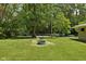 Lush backyard with fire pit area and ample green space for outdoor enjoyment at 6464 Whitley Ln, Indianapolis, IN 46260