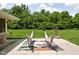 Expansive backyard featuring hammocks, lush lawn, and mature trees at 6464 Whitley Ln, Indianapolis, IN 46260