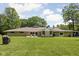 Spacious backyard with lush lawn, patio area, and mature trees provides privacy at 6464 Whitley Ln, Indianapolis, IN 46260