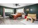 A beautifully designed bedroom featuring a ceiling fan, hardwood floors, and abundant natural light from two windows at 6464 Whitley Ln, Indianapolis, IN 46260