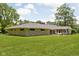 Rear exterior view of home with lush backyard and outdoor living space at 6464 Whitley Ln, Indianapolis, IN 46260