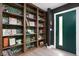 Hallway with beautiful built-in shelves and a green door at 6464 Whitley Ln, Indianapolis, IN 46260