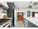 Open kitchen featuring two tone cabinets, an island with seating, and stainless appliances at 6464 Whitley Ln, Indianapolis, IN 46260