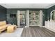 Spacious main bedroom with hardwood floors, custom walk-in closets, a statement chair, and access to a full bathroom at 6464 Whitley Ln, Indianapolis, IN 46260