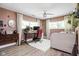 Bright office area with hardwood floors, large windows, desk and chair setup, ideal for remote work at 6464 Whitley Ln, Indianapolis, IN 46260