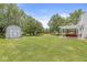 Spacious backyard features a storage shed, a pergola with seating, and a well-manicured lawn at 6601 Valley Forge Ct, Indianapolis, IN 46237