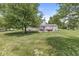 Spacious backyard with mature trees, a pergola, and lawn at 6601 Valley Forge Ct, Indianapolis, IN 46237