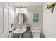 Charming half bathroom with pedestal sink, decorative mirror, and fresh decor at 6601 Valley Forge Ct, Indianapolis, IN 46237