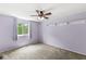 Inviting bedroom with a ceiling fan, a bright window, and soft lavender walls at 6601 Valley Forge Ct, Indianapolis, IN 46237