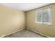 Minimalist bedroom with natural light and neutral carpet at 6601 Valley Forge Ct, Indianapolis, IN 46237