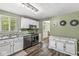 Well-lit kitchen features stainless steel appliances, wooden floors, and white cabinets at 6601 Valley Forge Ct, Indianapolis, IN 46237