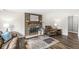 Cozy living room featuring a brick fireplace, a wooden mantel, and modern flooring at 6601 Valley Forge Ct, Indianapolis, IN 46237