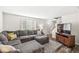 Comfortable living room with a sectional sofa, ottoman, and a modern entertainment center at 6601 Valley Forge Ct, Indianapolis, IN 46237