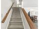 Carpeted staircase with wooden handrails leading to the upper level at 6601 Valley Forge Ct, Indianapolis, IN 46237