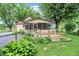 Exterior view of a home featuring a spacious backyard with a wooden deck at 6644 Mcfarland Rd, Indianapolis, IN 46227
