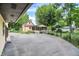 Exterior view featuring home, detached garage, and the driveway into the backyard at 6644 Mcfarland Rd, Indianapolis, IN 46227