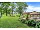 Exterior shot of deck and a backyard featuring lush greenery and mature trees at 6644 Mcfarland Rd, Indianapolis, IN 46227