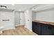 Finished basement with hardwood floors, bathroom with shower and bath tub, and cabinetry with wood countertop at 6644 Mcfarland Rd, Indianapolis, IN 46227