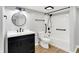 Basement bathroom with white vanity and updated fixtures, a bath tub, and shower at 6644 Mcfarland Rd, Indianapolis, IN 46227