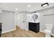 Basement bathroom with black vanity, updated fixtures, hardwood floors, updated lighting and a sliding door closet at 6644 Mcfarland Rd, Indianapolis, IN 46227