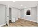 Finished basement featuring wood laminate flooring, a dehumidifier, window, and fresh neutral paint at 6644 Mcfarland Rd, Indianapolis, IN 46227
