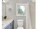 Bathroom with ceramic countertops, grey cabinetry, vanity mirror, updated fixtures, and a standing shower at 6644 Mcfarland Rd, Indianapolis, IN 46227