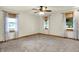 Open space with carpeting and three windows providing ample natural light at 6644 Mcfarland Rd, Indianapolis, IN 46227