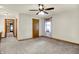 Empty bedroom space with neutral carpeting, ceiling fan and a closet in the corner at 6644 Mcfarland Rd, Indianapolis, IN 46227