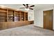 Large bedroom with carpet flooring, and custom wood built-ins for ample storage at 6644 Mcfarland Rd, Indianapolis, IN 46227