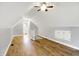 Finished attic bonus room with hardwood floors, ceiling fan, access to a bathroom, and built in storage at 6644 Mcfarland Rd, Indianapolis, IN 46227