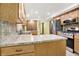 Well-lit kitchen with stainless steel appliances, stone countertops, and mosaic tile backsplash at 6644 Mcfarland Rd, Indianapolis, IN 46227