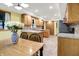 Bright kitchen featuring wood cabinets, modern appliances, and a charming dining area at 6644 Mcfarland Rd, Indianapolis, IN 46227