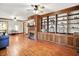 Spacious living room featuring hardwood floors, a cozy fireplace, and custom built-in shelving at 6644 Mcfarland Rd, Indianapolis, IN 46227