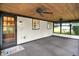 Charming sunroom featuring knotty pine ceilings, neutral walls and carpet, and an abundance of windows at 6644 Mcfarland Rd, Indianapolis, IN 46227