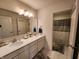 Spacious bathroom with double sink vanity, large mirror, and separate shower area at 6731 Keepsake Dr, Whitestown, IN 46075